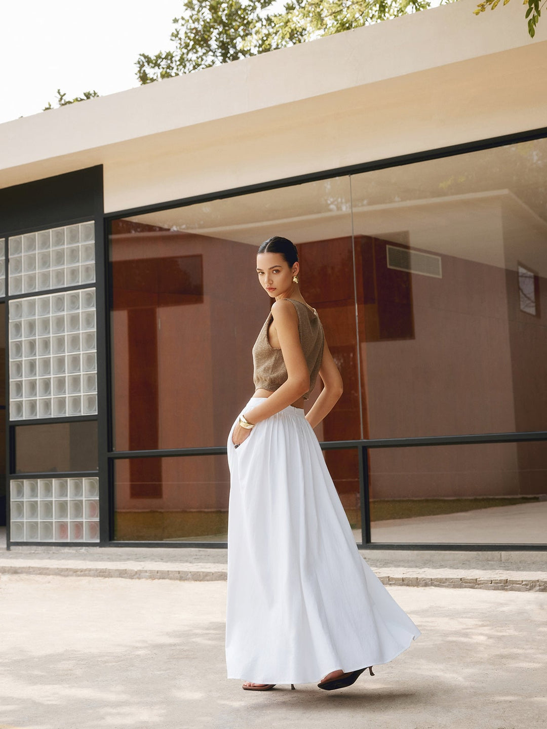 Close-up of pleated waistband detail on Florence white maxi skirt