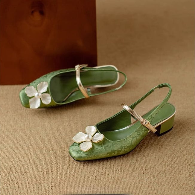Close-up of pearl-centered floral embellishment on the toe of the Florine slingback pump in green