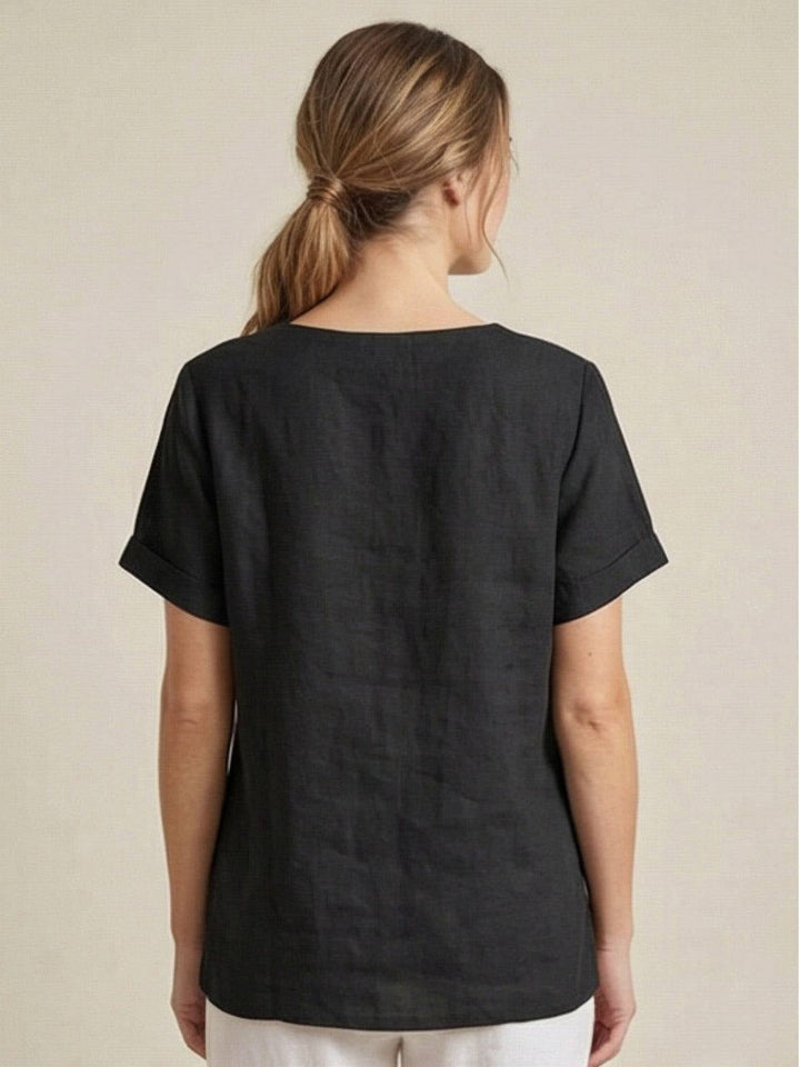 Model wearing Foreen top in Navy Blue tucked into high-waisted jeans