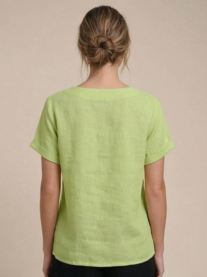 Close-up of drop-shoulder seam and cuffed sleeve on Foreen casual top in Navy Blue