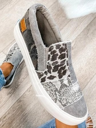 Frances slip-on shoes in gray paired with slim-fit jeans on a female model