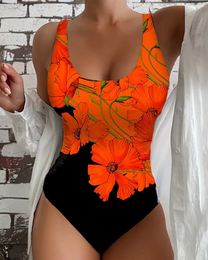 Woman wearing the Francesca orange and black floral one-piece swimsuit with a flattering contoured silhouette