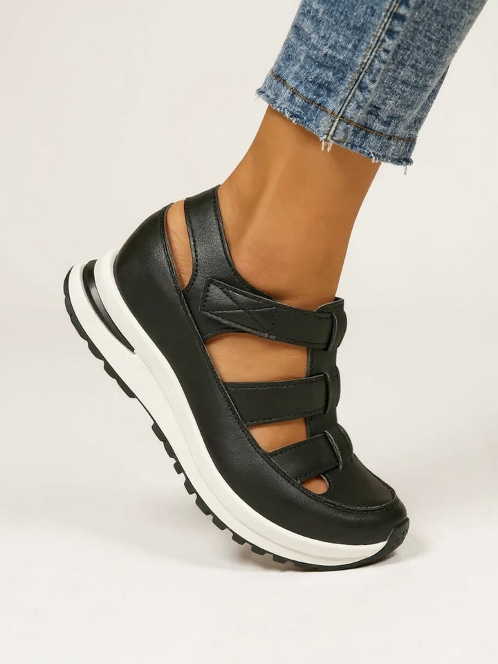 Freesia women's black platform sandals, side profile showing lifted sole