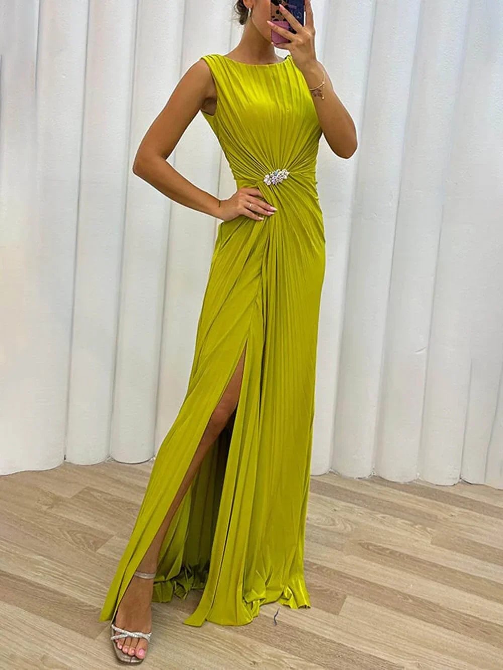 Woman wearing a yellow pleated maxi dress with flowing silhouette, perfect for wedding guests and formal occasions