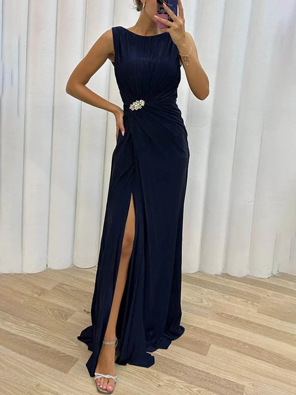 Front view of the Freesia pleated maxi dress in navy blue showing defined waist and elegant drape