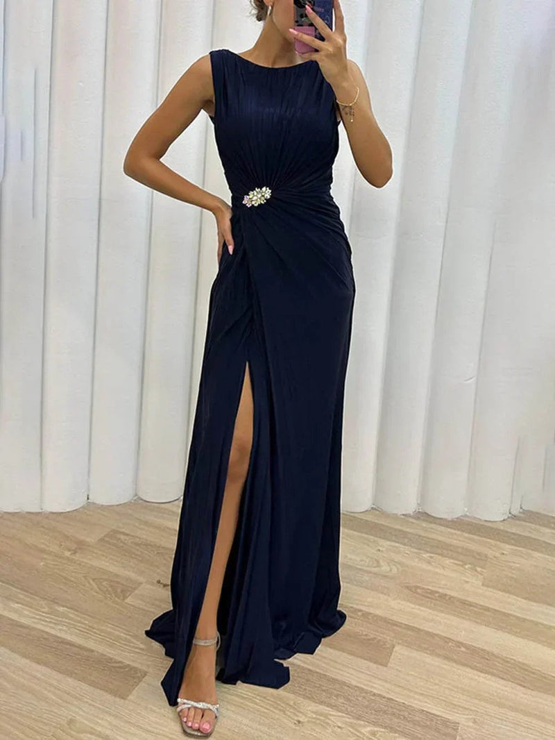 Front view of the Freesia pleated maxi dress in navy blue showing defined waist and elegant drape