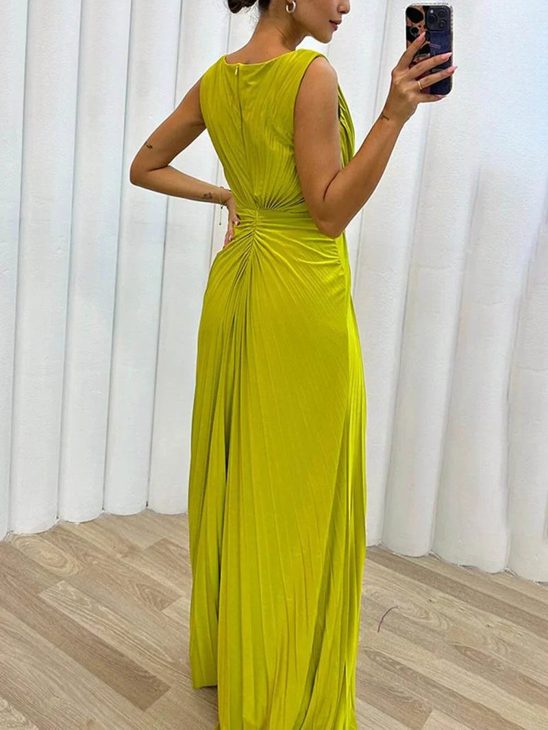 Full-length side view of model in the Freesia pleated maxi dress showing elongating silhouette and maxi length