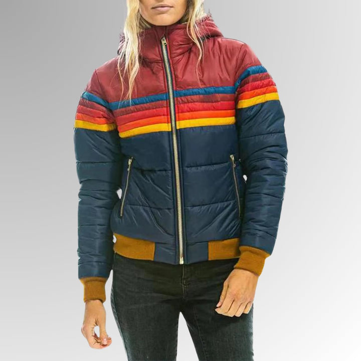 Close-up of rainbow stripe trim on a retro zip-up jacket in marine blue