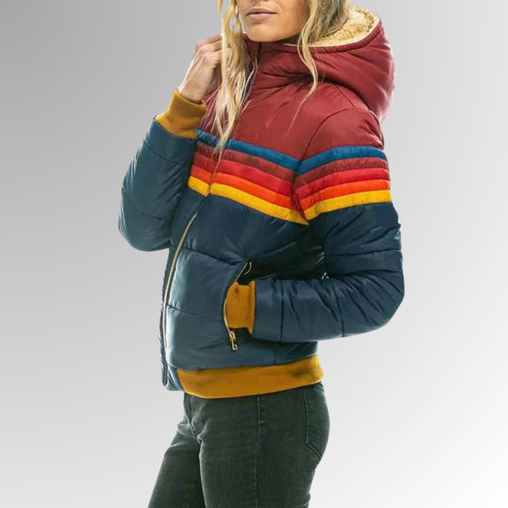 Flat lay of retro rainbow stripe zip-up jacket in black showing full zip and stripe detail
