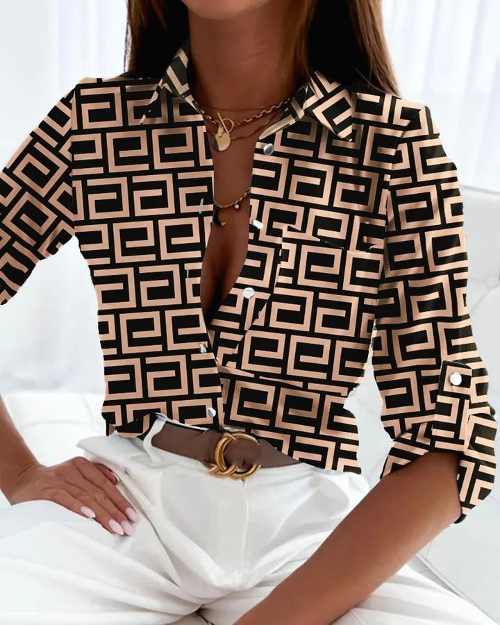 Woman styling an elegant abstract print blouse with tailored trousers for a polished daytime look