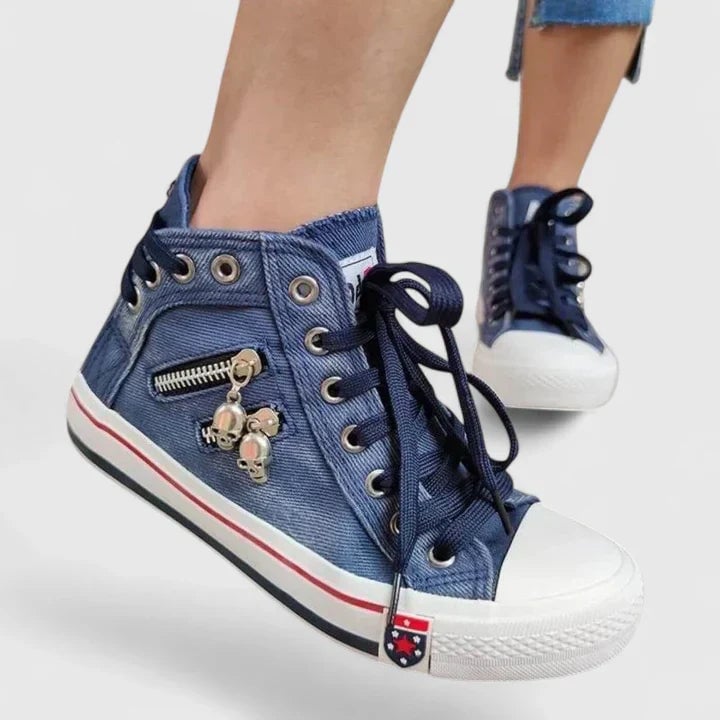Close-up of Freya high-top sneaker side zipper with decorative pull on denim canvas upper