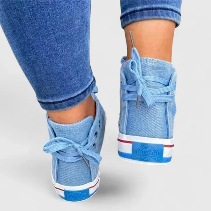 Freya navy blue high-top sneaker side profile highlighting the retro stripe midsole detail
