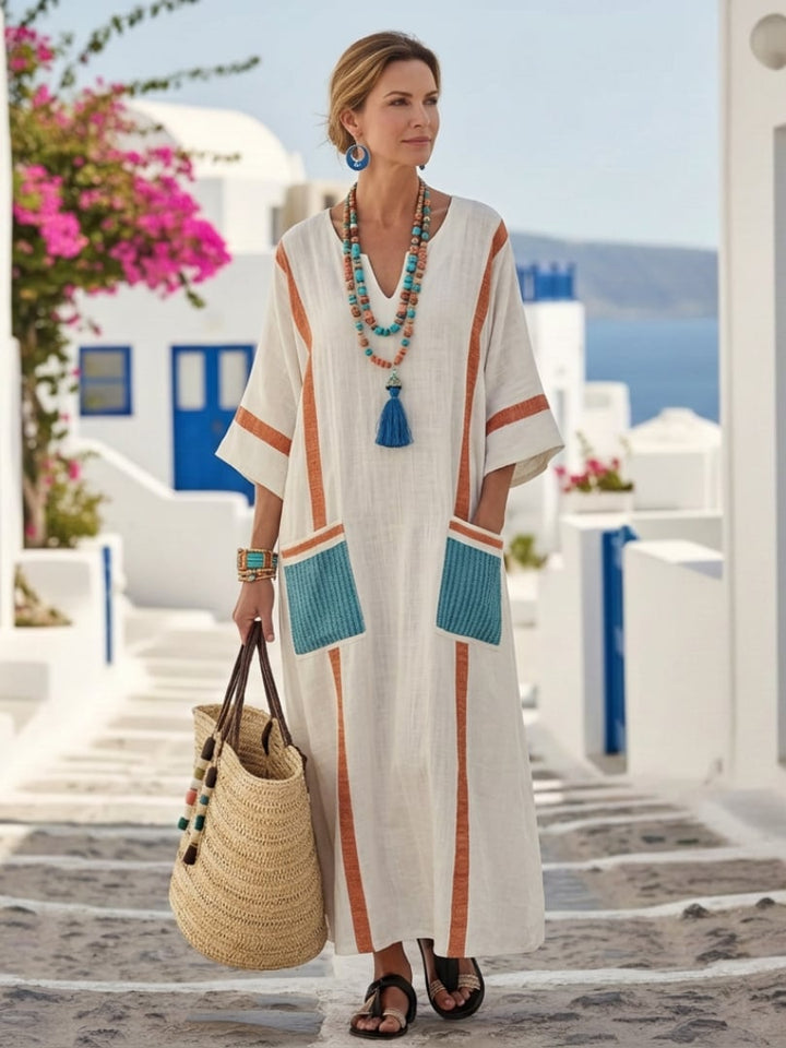 Side view of the Freya orange V-neck maxi dress showing flowing silhouette and front pocket