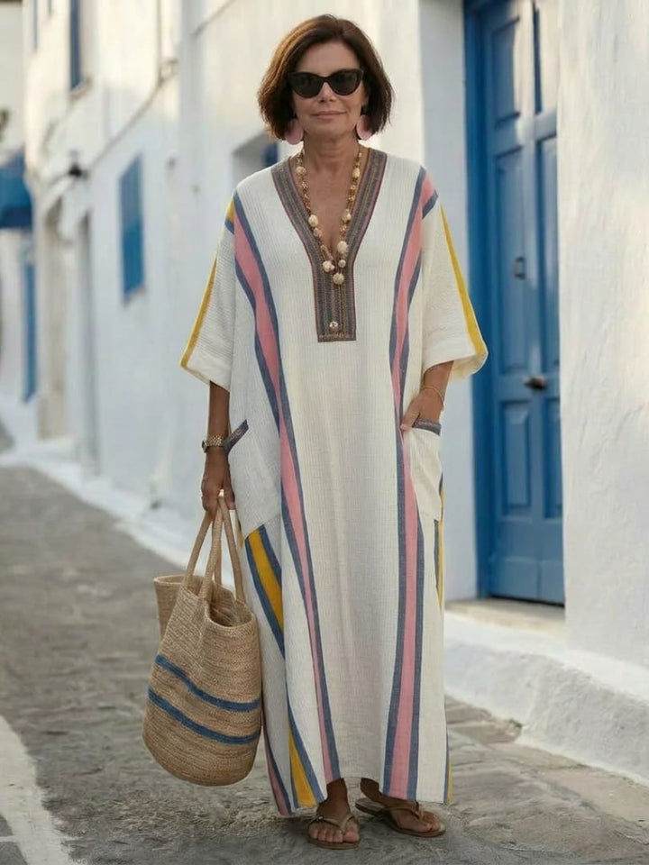Lifestyle shot of woman wearing the Freya pink V-neck maxi dress outdoors in natural light
