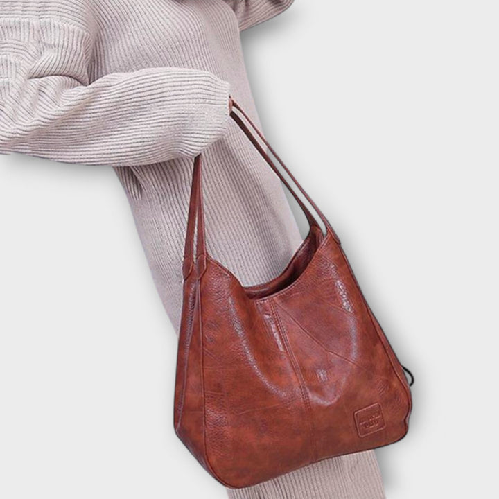 Red shoulder bag with timeless design shown against a clean background