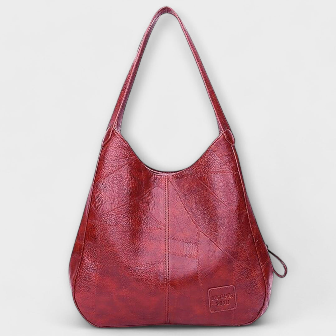 Brown shoulder bag laid flat to show overall shape and clean design