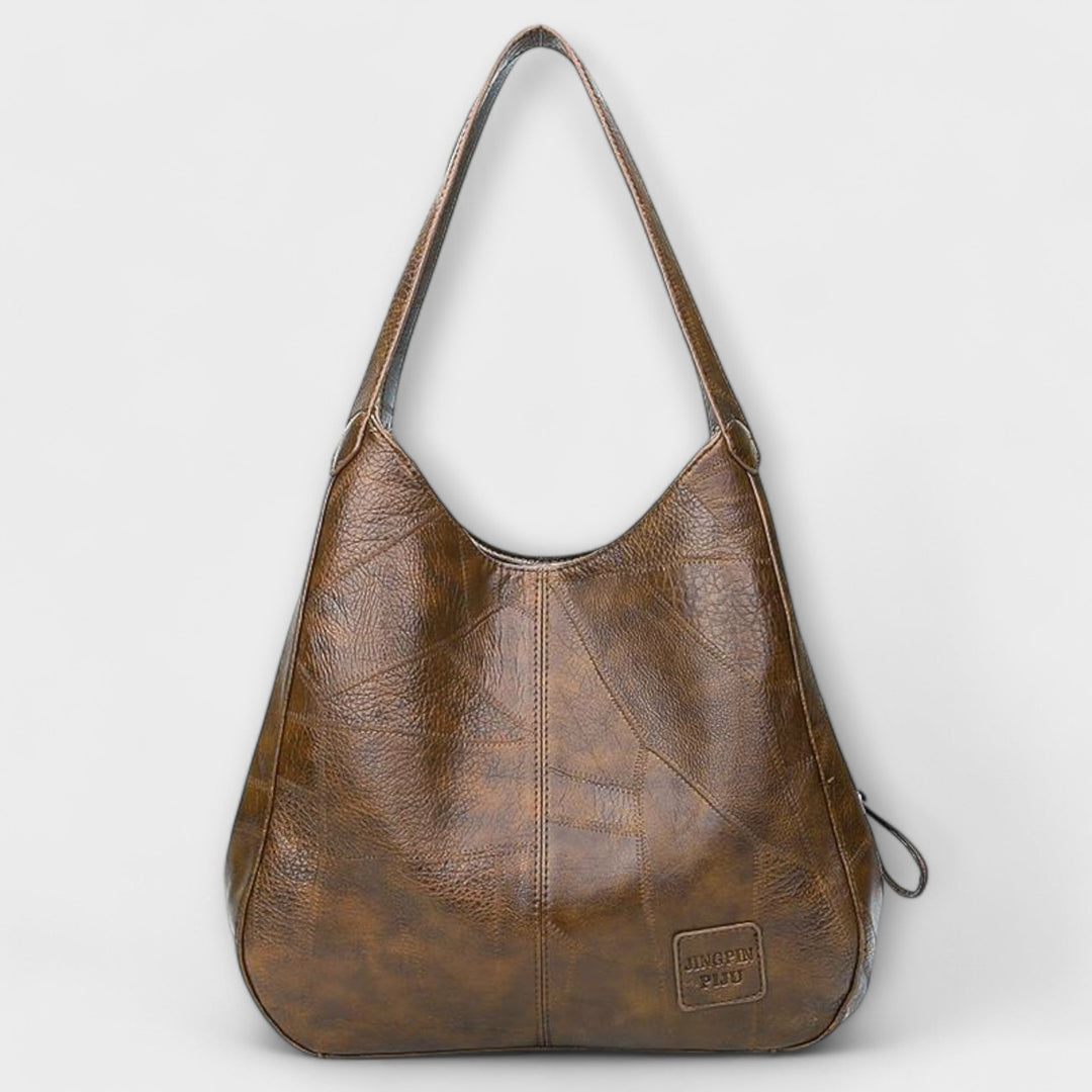 Four color options of the minimalist shoulder bag: black, red, brown, and dark brown