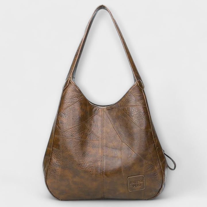 Four color options of the minimalist shoulder bag: black, red, brown, and dark brown