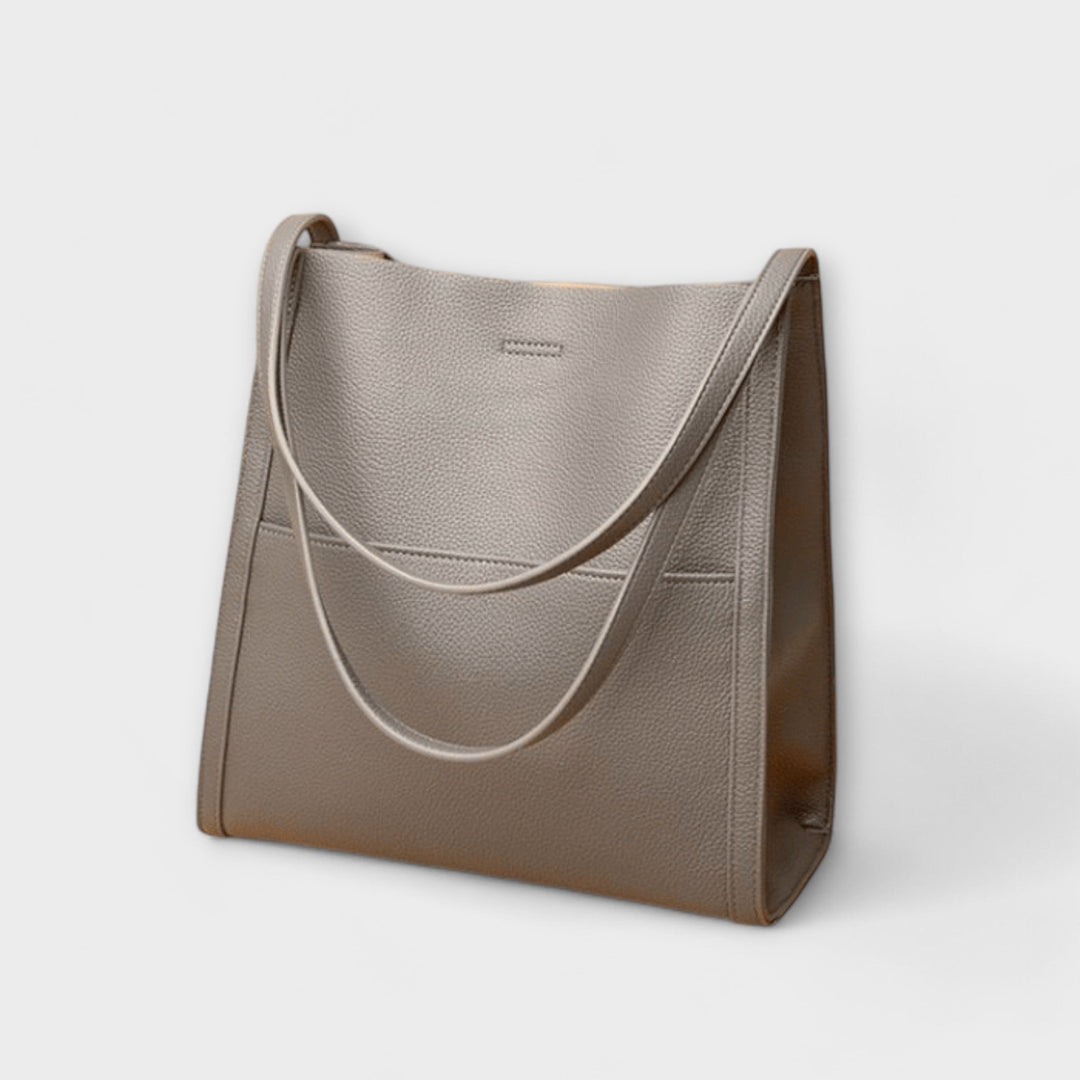 Close-up of Freydis handbag shoulder straps and top handle detail