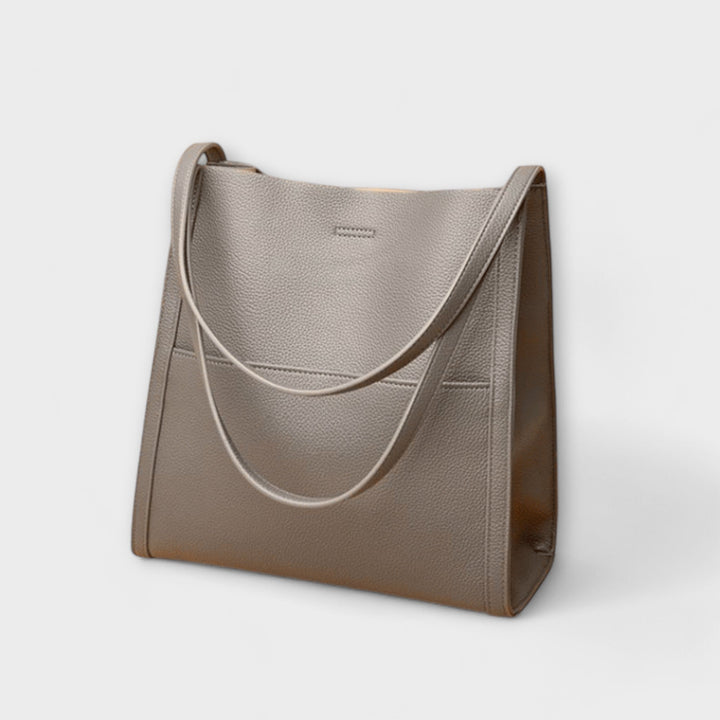Close-up of Freydis handbag shoulder straps and top handle detail