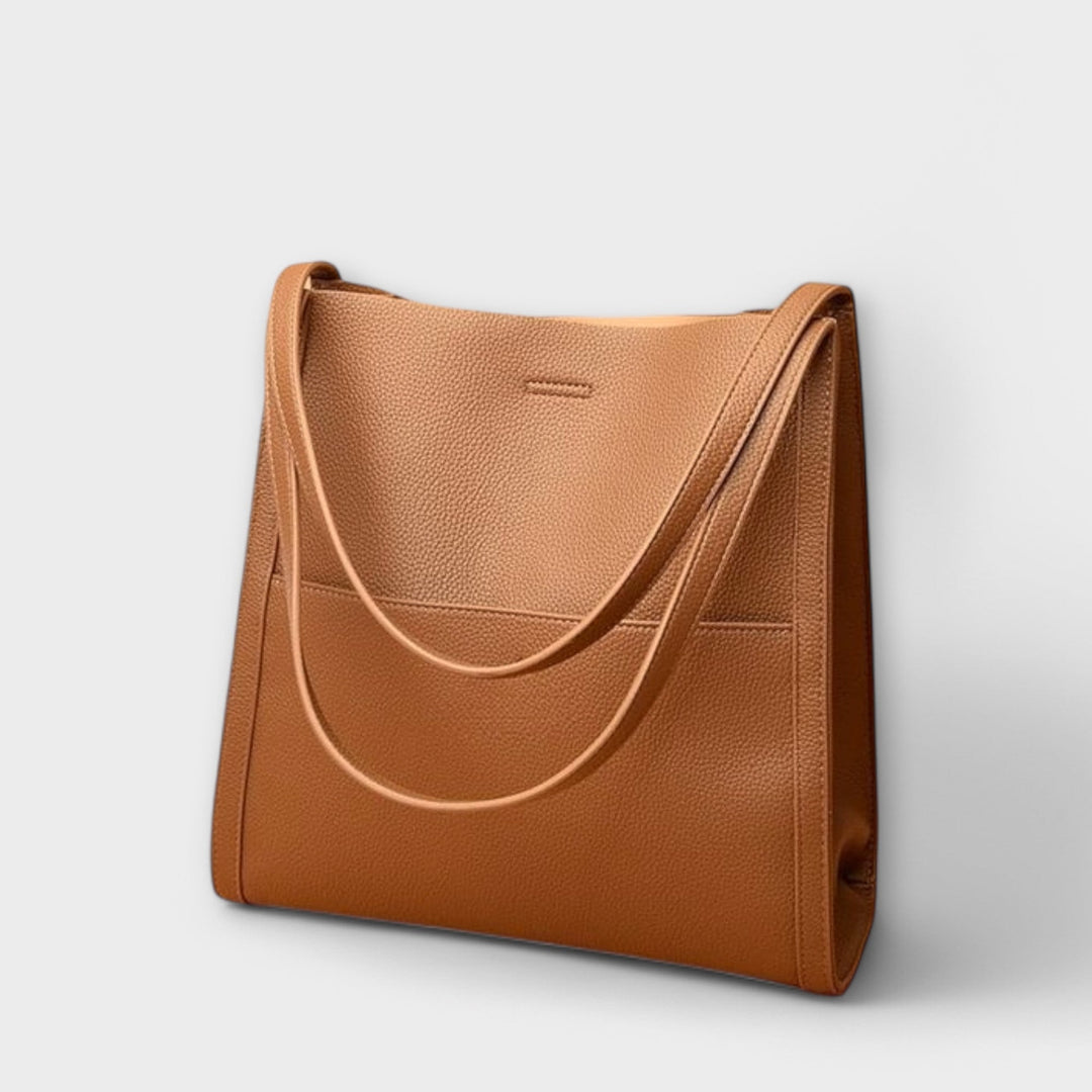 Freydis handbag lifestyle shot carried on shoulder by a woman in casual outfit