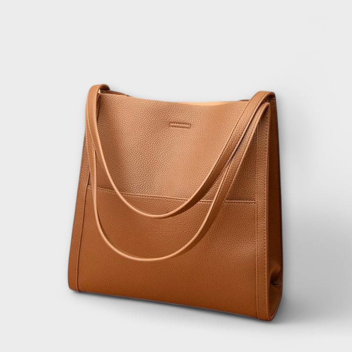 Freydis handbag lifestyle shot carried on shoulder by a woman in casual outfit