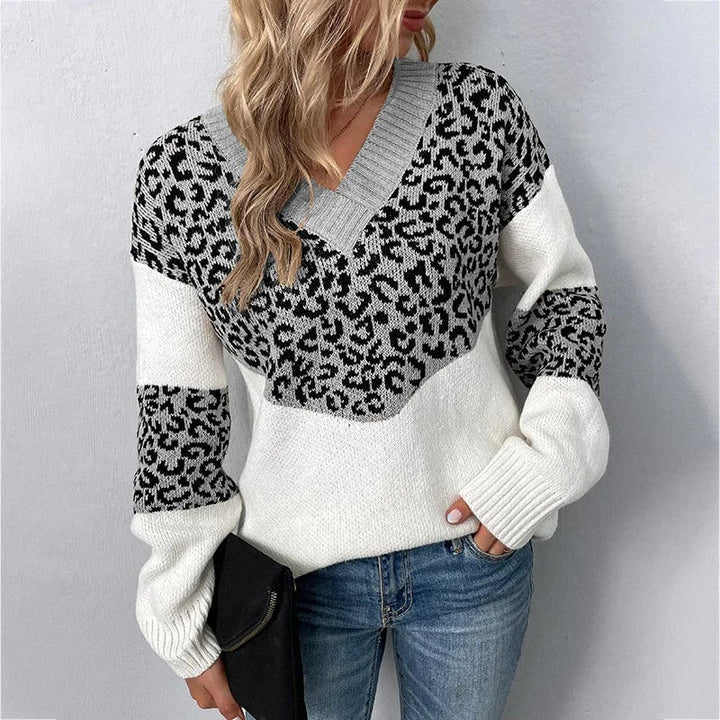Woman wearing a grey V-neck leopard print sweater with a flattering neckline and chic animal print pattern