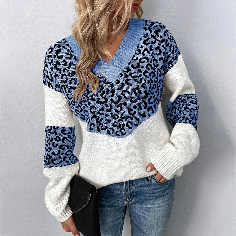 Woman styled in a dark blue leopard print V-neck sweater paired with jeans for a polished casual look