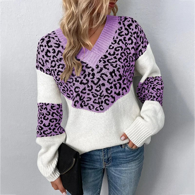 Woman wearing a beige V-neck leopard print sweater layered over tailored trousers for a refined everyday outfit
