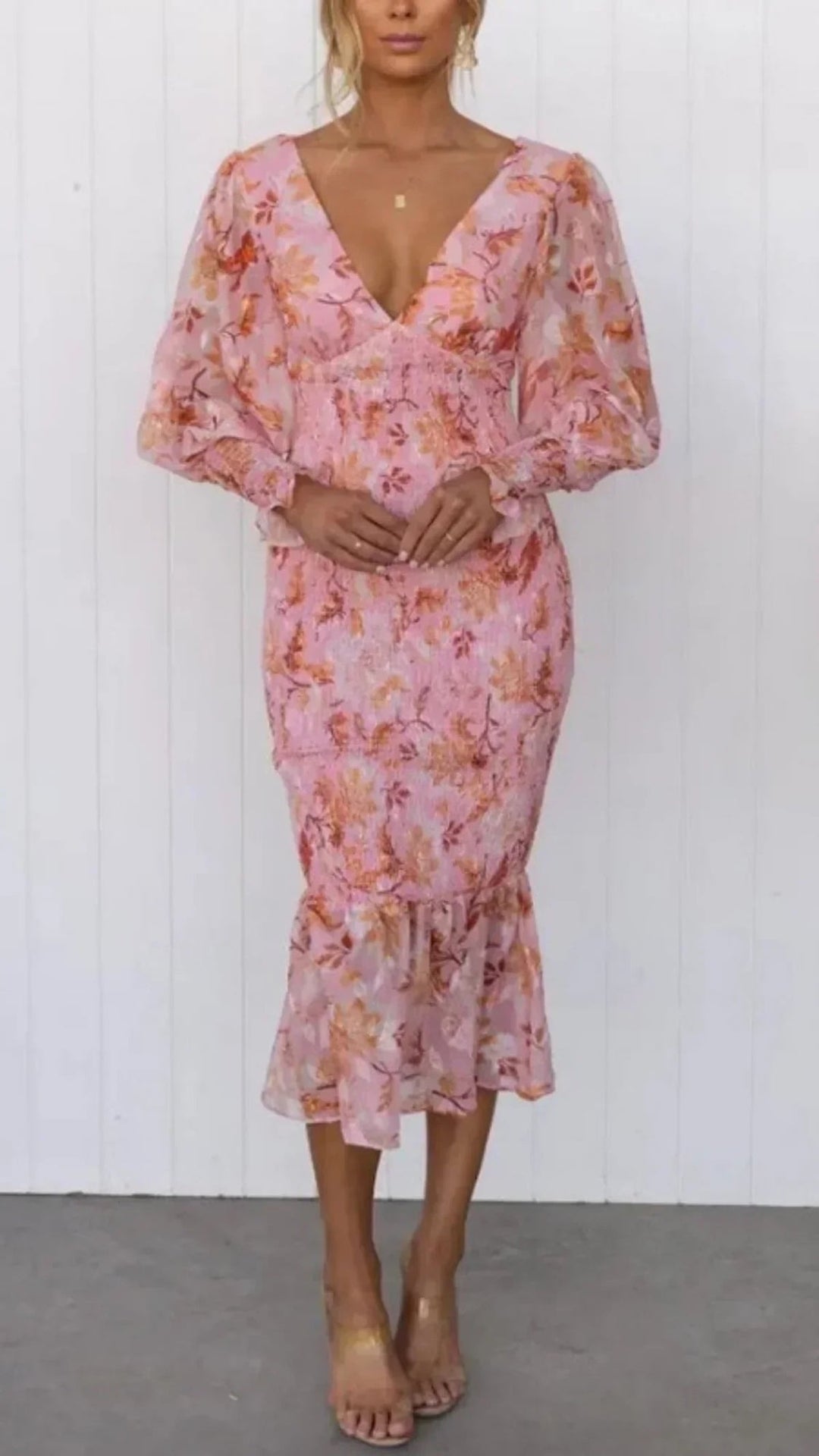 Woman wearing the Gabrielle floral flowy draped dress in pink, full-length front view