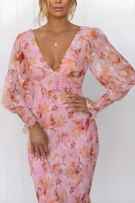 Side view of the Gabrielle floral dress showing the flowing draped silhouette