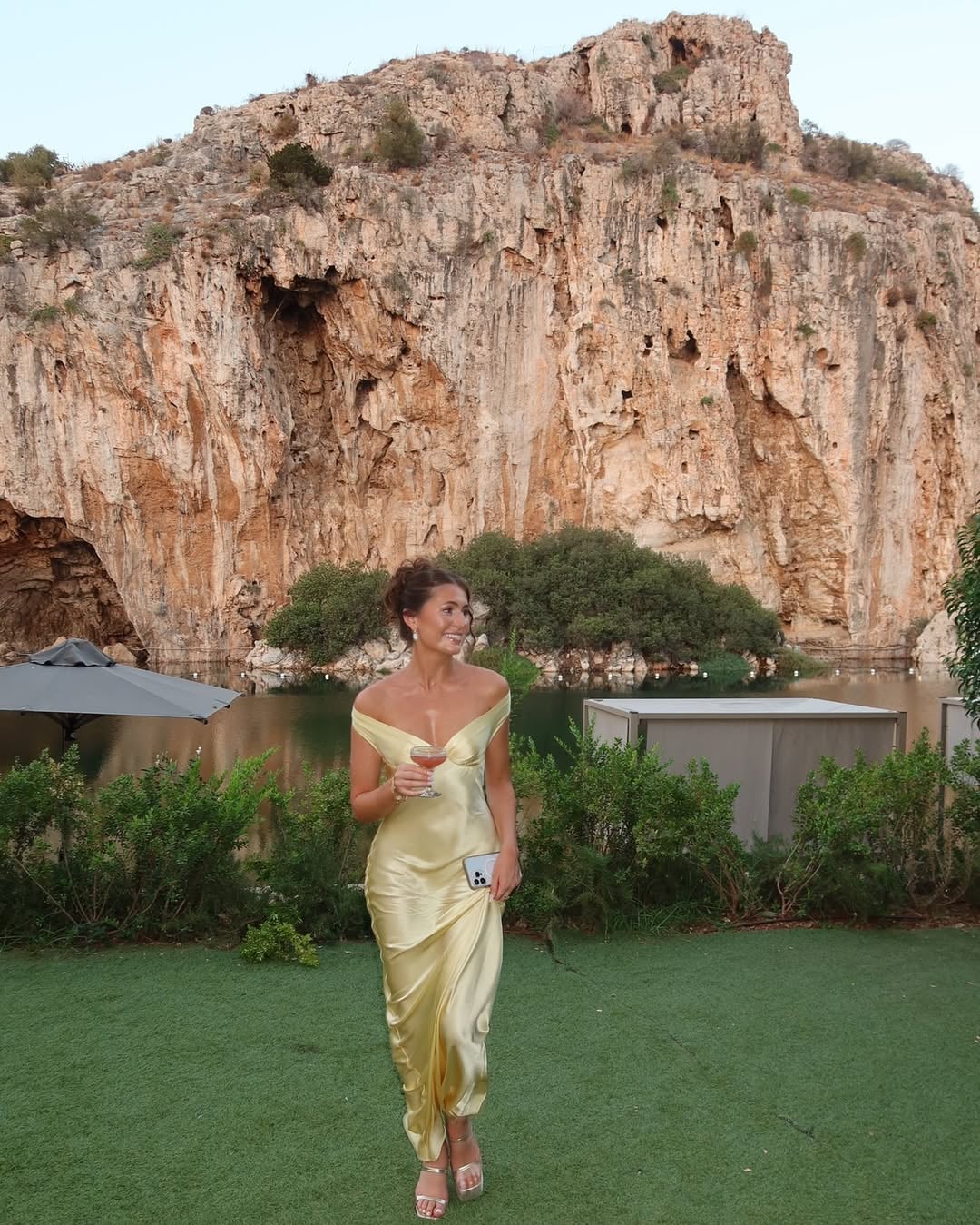 Back view of the Gabrielle gold off-shoulder satin evening dress showing the smooth drape and tailored fit