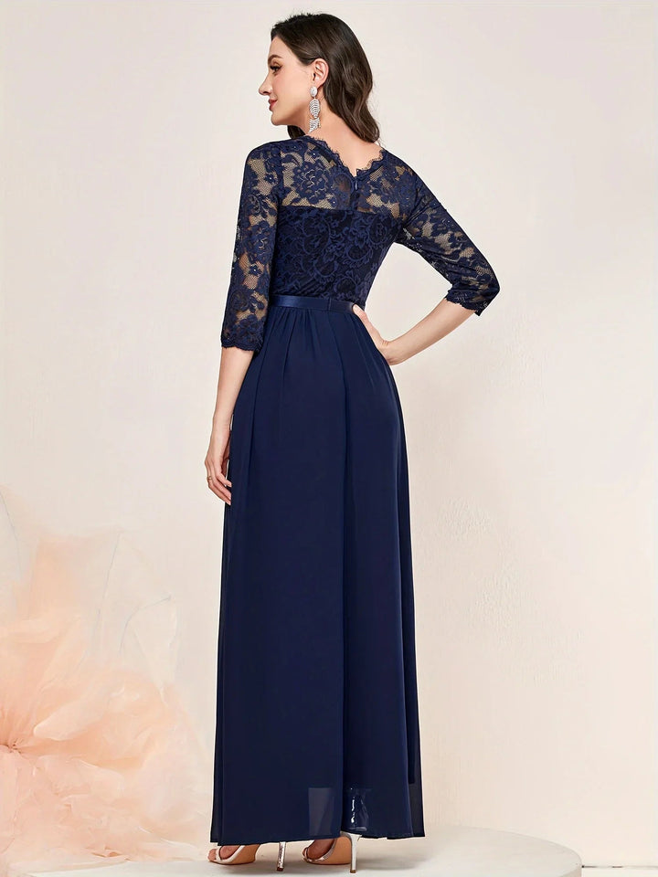 Full-length view of blue lace pleated maxi dress showing floor-grazing silhouette