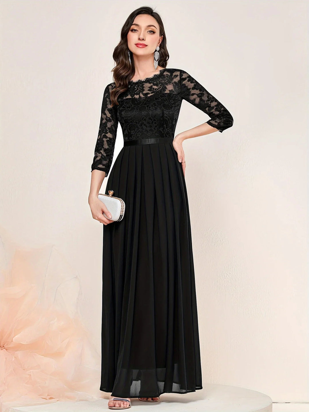 Model wearing red lace maxi dress paired with heeled sandals for a wedding guest look