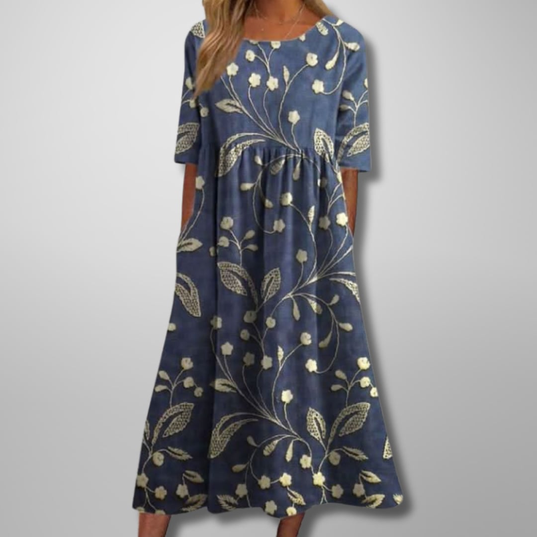 Woman wearing a relaxed floral midi dress in a soft colorway, styled for a casual daytime look