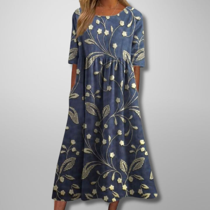 Woman wearing a relaxed floral midi dress in a soft colorway, styled for a casual daytime look