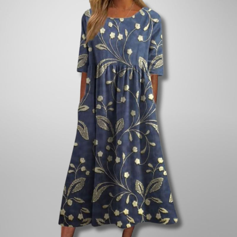 Woman wearing a relaxed floral midi dress in a soft colorway, styled for a casual daytime look