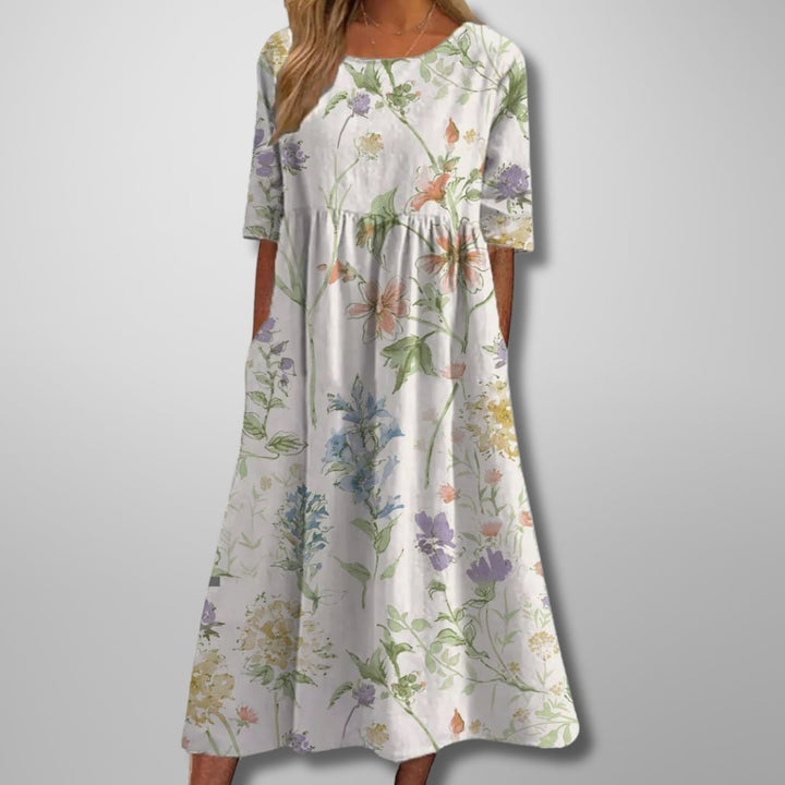 Model in the relaxed floral midi dress posed outdoors in a garden setting