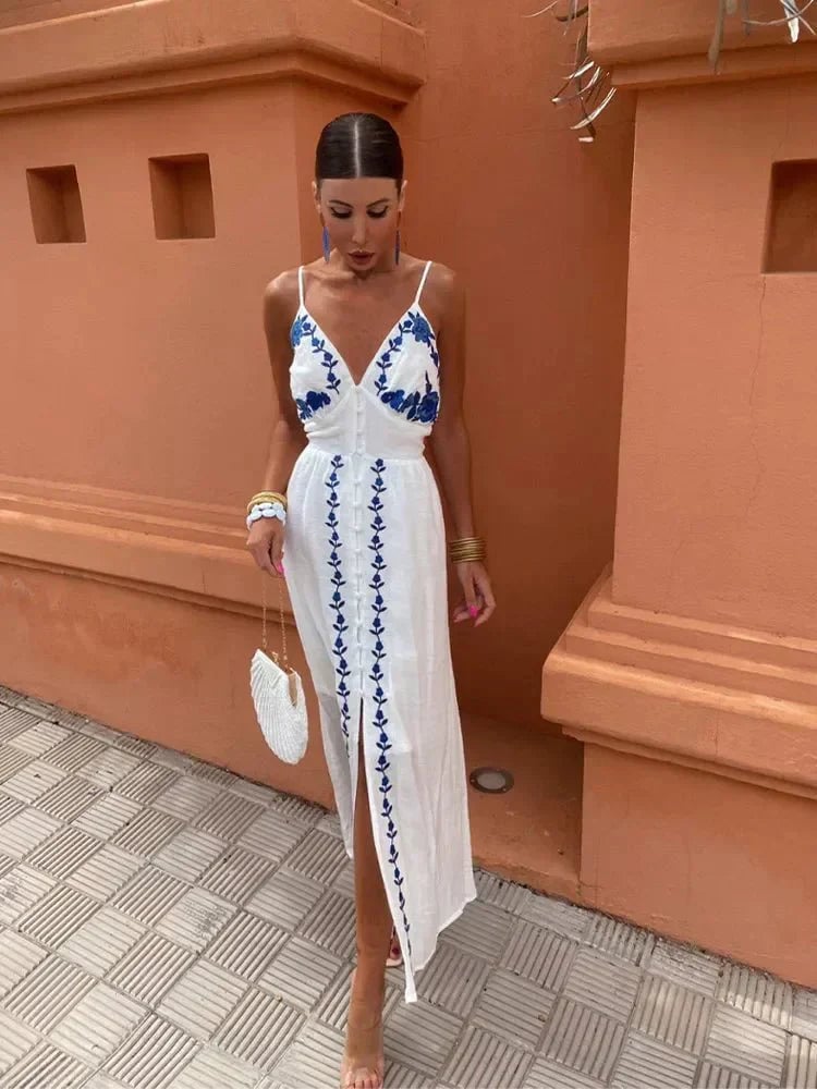 Woman wearing the Gardenia white flowing wedding guest dress in a bright outdoor setting