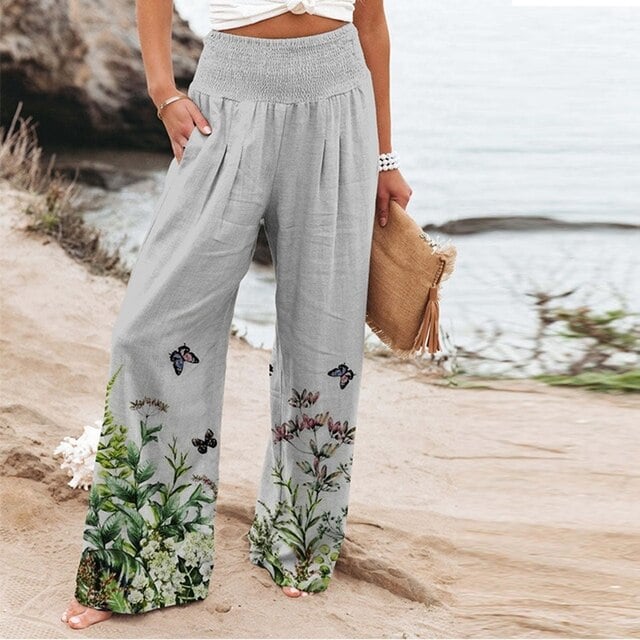 Floral wide-leg pants in green colorway styled with a white fitted top, full-length front view
