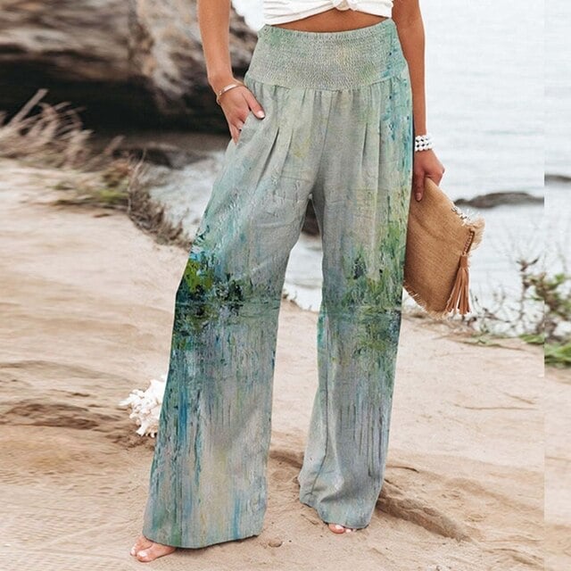 Light green botanical print wide-leg pants with relaxed silhouette, side view on model