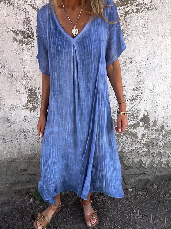 Front view of flowy draped maxi dress in blue with elegant full-length silhouette