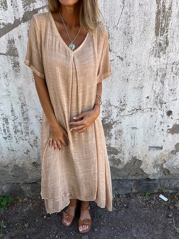 Side view of draped maxi dress showing fluid fabric movement in pink