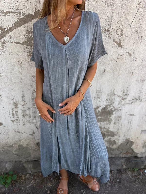 Full-length shot of flowy maxi dress in grey on model showing elongated silhouette