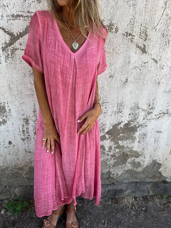 Grey flowy maxi dress styled with a fitted blazer for an evening look