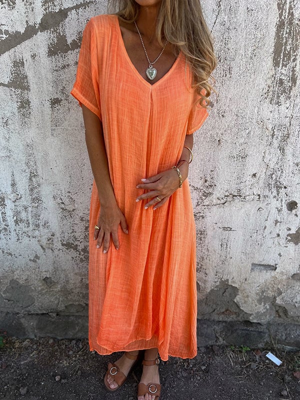 Flat lay of flowy draped maxi dress in all five available color options
