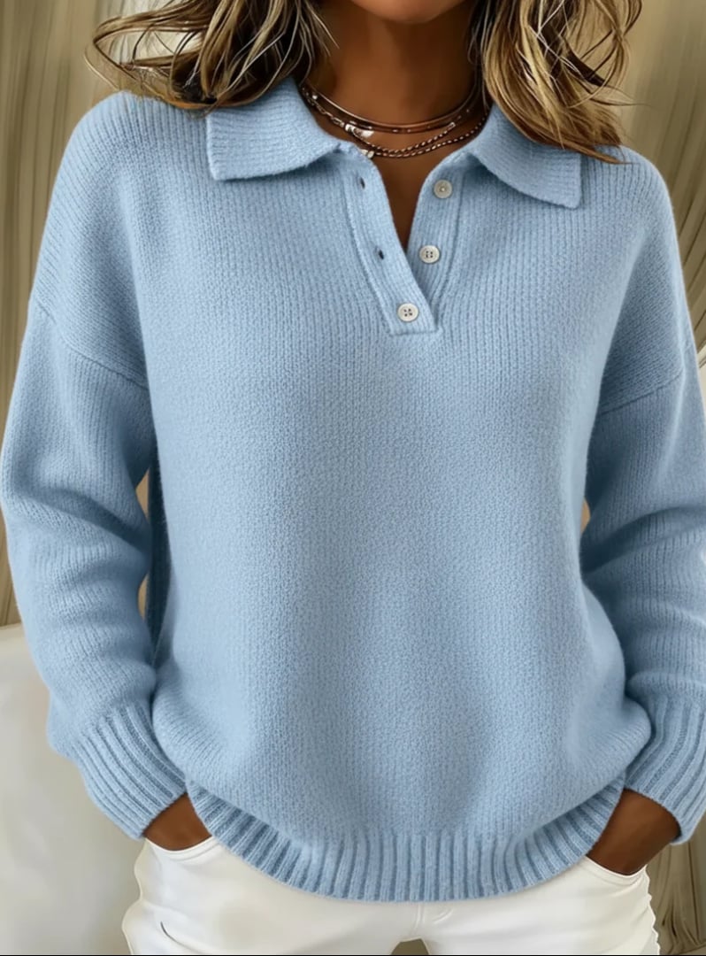 Woman wearing a light blue polo sweater with structured collar and button detail, relaxed fit, front view
