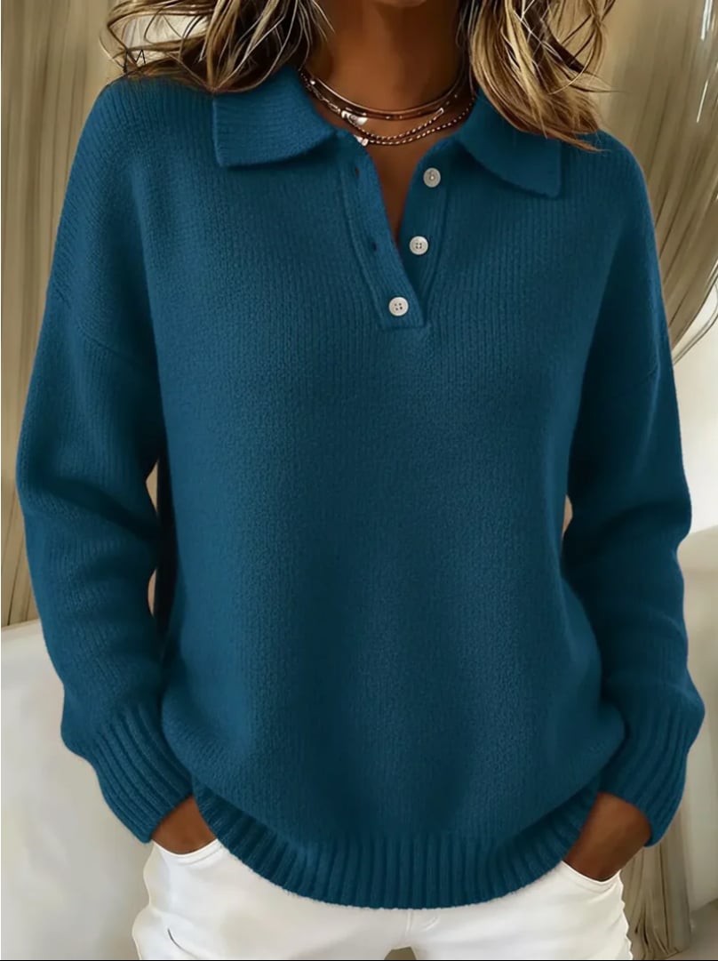 Close-up of the Genesis polo sweater showing soft fabric texture and classic polo collar in light blue
