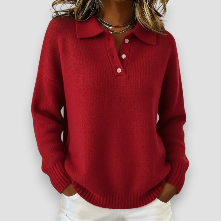 Woman wearing a blue polo sweater paired with jeans, casual weekend outfit, smiling front-facing pose
