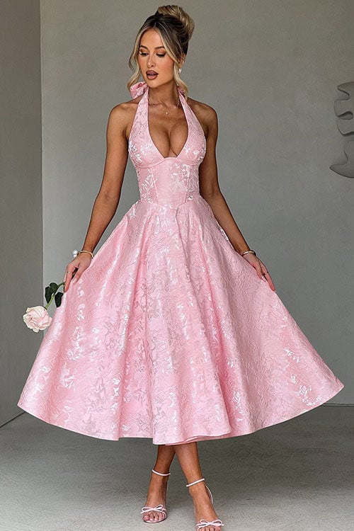 Pink halterneck jacquard maxi dress on a model showing the open neckline and shoulder detail